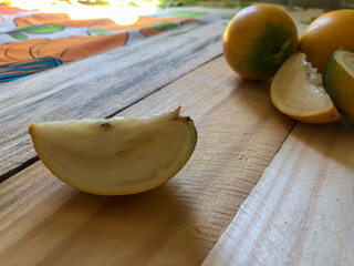 Abiu fruit cut on rustic wooden board ready for consumption