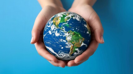 people, geography, population and peace concept - close up of human hands with earth globe showing continent over blue background