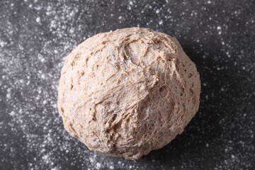 Fresh sourdough and flour on grey table, top view