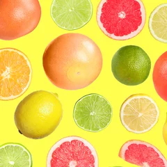Schilderijen op glas Many different fresh citrus fruits falling on yellow background © New Africa