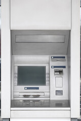 Modern automated cash machine with screen outdoors