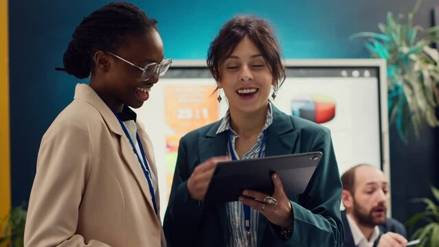 Corporate workers looking into project updates and timelines in boardroom, establishing budget and activities to achieve strategic objectives in a competitive business environment. Camera A.