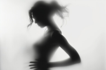 Woman silhouette behind opaque glass. Artistic photo of woman figure behind blurred, sanded glass and transparent curtain. Captivating Portrait Behind Opaque Glass.