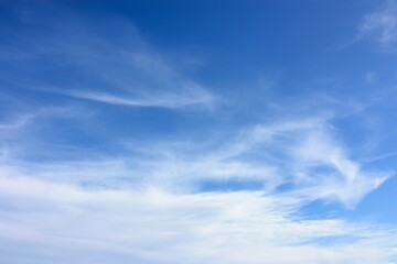 Tranquil beauty of wispy white clouds drifting across the clear azure sky, painting a mesmerizing...