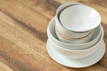 Stack of clean dishes on wooden table