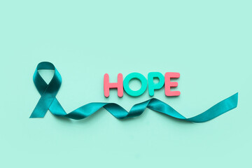 Teal ribbon and word HOPE on turquoise background. Sexual Assault Awareness Month