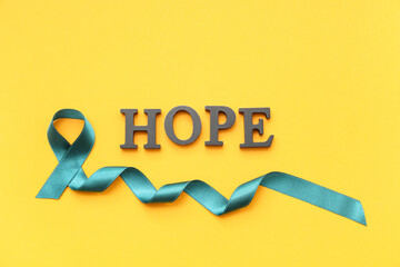 Teal ribbon and word HOPE on yellow background. Sexual Assault Awareness Month