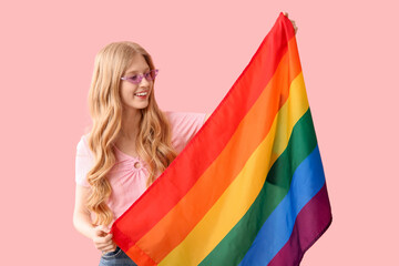 Beautiful young happy woman with LGBT flag on pink background