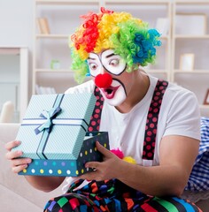 Drunk clown celebrating having a party at home - 782618587