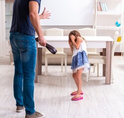 Angry father punishing his daughter - 782623509