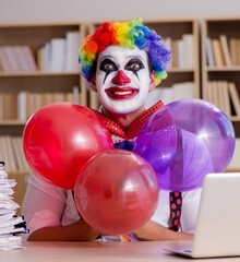 Clown businessman working in the office - 782624376