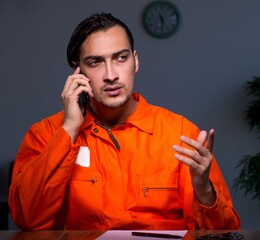 Young convict man sitting in dark room - 782627743