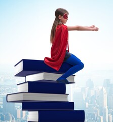 Superhero little girl in education concept