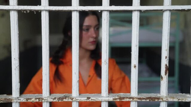 Female Woman Prisoner in Orange Jumpsuit Prison in Jail Cell
