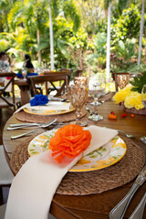 Mexican themed event setting decoration dinner table setting plates glassware on tropical forest background