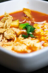 Chef wearing pink jacket preparing food, soup, mexican food, mexican cuisine, tortilla soup, tomato soup