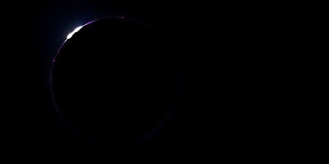 Color photo of the April 8, 2024 solar eclipse as seen from Carbondale IL. As it approaches totality, Baily's beads are visible when the last glimpse of sunlight shines through the moon's terrain.