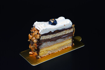 A piece of cake isolated on black background. French style Chocolate cake