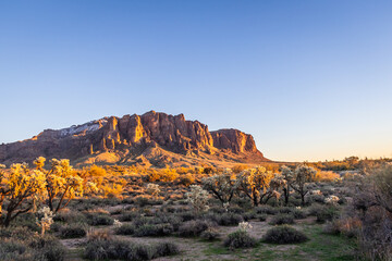 Evening photo of the Superstition Mountains in Arizona and clear blue sky.