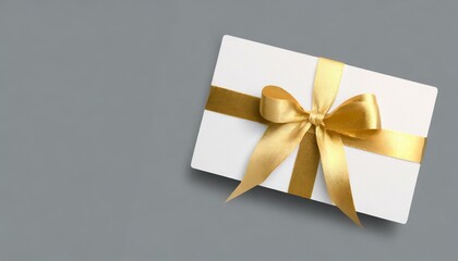 blank golden gift card with a vibrant black ribbon bow right side, a minimalist grey background with subtle shadowing.gift card with golden ribbon 