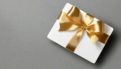 gift card with golden ribbon, blank golden gift card with a vibrant black ribbon bow right side, a minimalist grey background with subtle shadowing. 