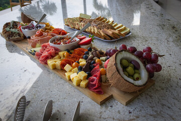 Creative beautiful cheese board on marble table at cocktail party setting