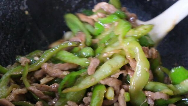 Stir fry Shredded Pork with Green Pepper. Cooking Chinese food in wok. Super slow motion
