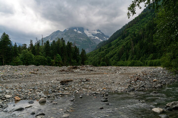 View of the Psysh River and the Amanauz-Bashi Mountain of the Northern Caucasus Mountains near the village of Arkhyz on a sunny summer day, Karachay-Cherkessia, Russia