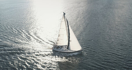 Sun light at sea bay with luxury yacht reflection aerial. Epic passenger sailboat cruise at open...