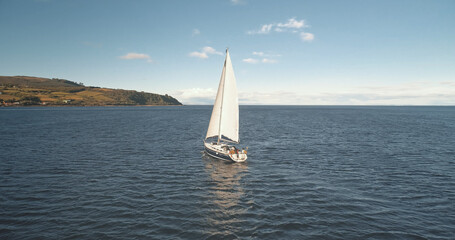 Slow motion of yacht reflection at sea gulf aerial. Alone sail boat reflect at ocean bay. Racing...
