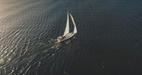 Yacht sailing on open sea at sun shine aerial. Serene seascape and water transportation. Lonely...