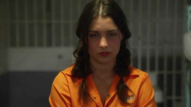 Female Woman Prisoner in Orange Jumpsuit Prison in Jail Cell