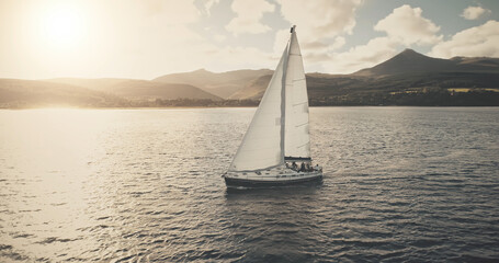 Sun seascape with white sailboat aerial. Mesmerezing landscape with sail boat at summer. Sunlight...