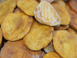 Dried Peaches on a Wooden Background: Embodiment of Sun Warmth and Sweet Aroma