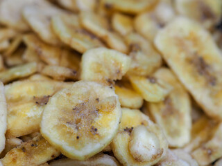 Obraz na płótnie Canvas Close-Up of Banana Chips with Light Dark Spots, an Invitation to Tropical Flavor
