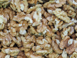 “Close-up of Walnut Kernels on a Dark Background, Symbolizing Natural Strength and Energy”