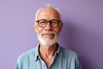 Portrait of a smiling senior man with glasses against a purple background