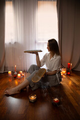 young woman indoor with nail board and burning candles - 782720367