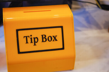 close up of a tips box in a cafe 