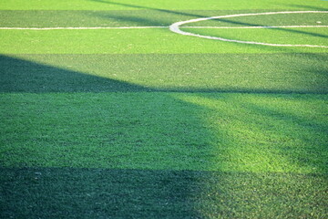 artificial green grass soccer field with sunlight, training football yard