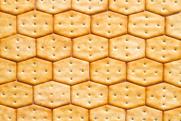 Hexagonal cracker honeycomb texture. The background texture of the cookies.