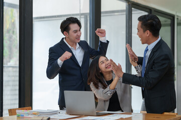 Great job! Successful business team is clapping their hands in modern workstation, celebrating the performance of new product