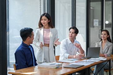 New-generation businessmen, creative professionals, and accountants meet to discuss business, brainstorm ideas, and project analysis reports. Check online investment results and company profits.