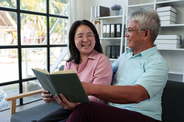 Surprised Asian woman hugs elderly father Teasing in various verses Reading in the living room holidays family relationships Holiday celebration Father's Day and elderly people's health care concept.