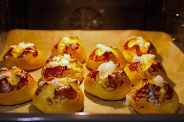 Group of delicious buns baking in oven