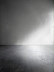 A large empty room with a white wall and a grey floor. The room is bare and empty, with no...