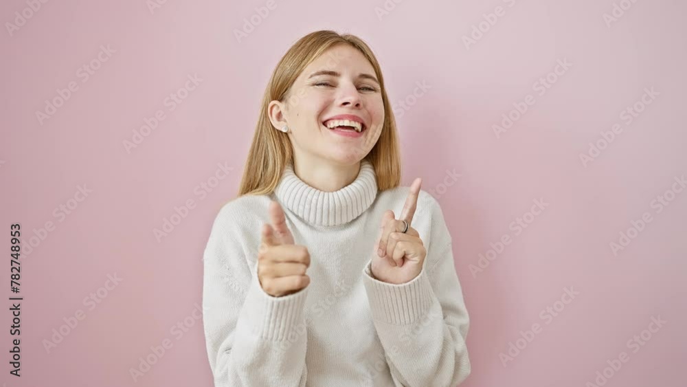 Sticker cheerful blonde girl with blue eyes and trendy sweater, flashing a great smile, hands pointing at yo