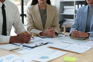 Team of business people analyzing, discussing, calculating earnings from earnings charts and graphs Growth with laptop computers and brainstorming strategies for new projects. startup business ideas