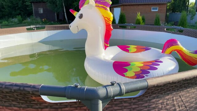 Children's inflatable swimming ring in the outdoor pool.