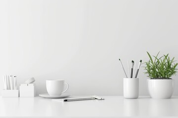 Minimalist white desk with potted plant, coffee cup, and neatly arranged office supplies - obrazy, fototapety, plakaty